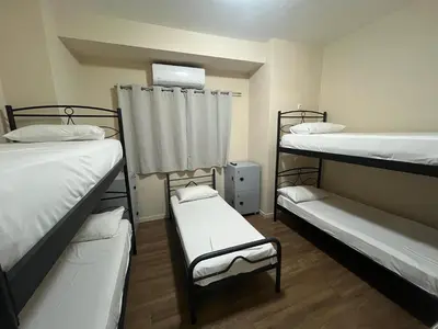 a room with three bunk beds and a window at Paloma in Athens