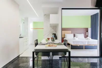 a bedroom with a bed and a table with food on it at Greece U Around Athens Thissio Suites in Athens