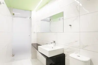 a white bathroom with a sink and a toilet at Greece U Around Athens Thissio Suites in Athens