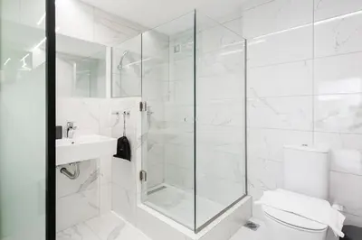 a bathroom with a shower and a toilet and a sink at Greece U Around Athens Thissio Suites in Athens