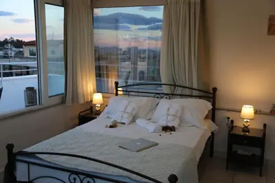 a bedroom with a bed with a laptop on it at Flat in Monastiraki with stunning view of Acropolis in Athens