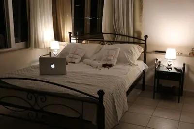 a bedroom with a bed with a laptop on it at Flat in Monastiraki with stunning view of Acropolis in Athens