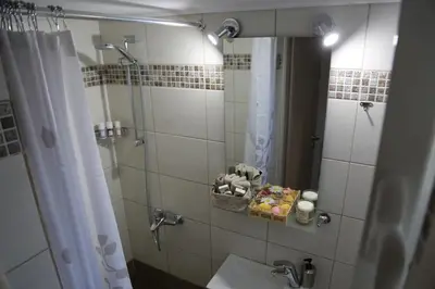 a bathroom with a shower and a sink and a mirror at Flat in Monastiraki with stunning view of Acropolis in Athens