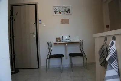 a small table with two chairs next to a door at Flat in Monastiraki with stunning view of Acropolis in Athens