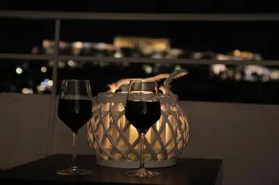 two glasses of wine on a table with a basket at Flat in Monastiraki with stunning view of Acropolis in Athens