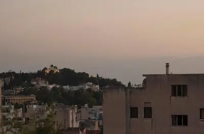 a view of a city with a house on a hill at Mosaics Astonishing Acropolis view Aprtm in Athens