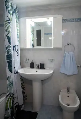 a bathroom with a sink and a toilet and a mirror at Mosaics Astonishing Acropolis view Aprtm in Athens