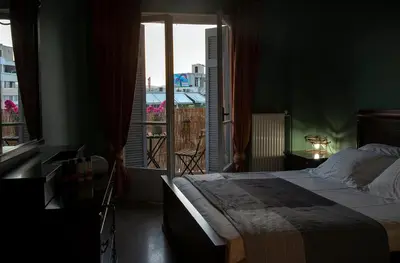 a bedroom with a large bed and a large window at Mosaics Astonishing Acropolis view Aprtm in Athens