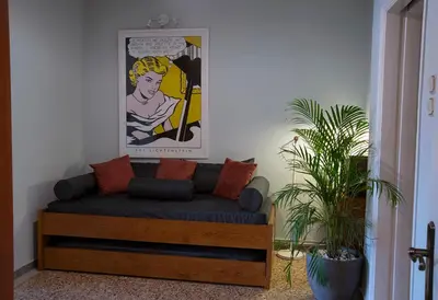 a couch in a living room with a painting on the wall at Mosaics Astonishing Acropolis view Aprtm in Athens