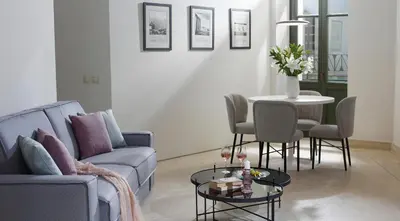 a living room with a couch and a table at Thission Luxury Homes & SPA by K&K in Athens