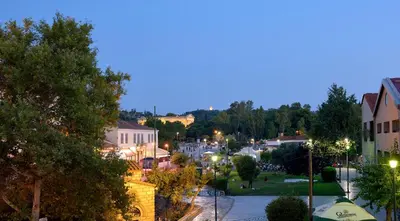 a view of a town at night at Thission Luxury Homes & SPA by K&K in Athens
