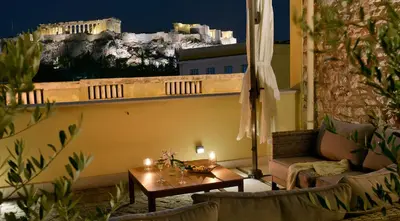a living room with a couch and a table with candles at Thission Luxury Homes & SPA by K&K in Athens