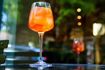 a drink in a glass sitting on a table at The Artist Athens in Athens