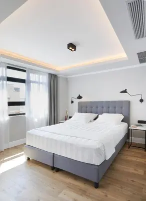 a bedroom with a large bed with white sheets at The Artist Athens in Athens