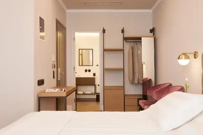 a bedroom with a bed and a desk and a mirror at The Artist Athens in Athens