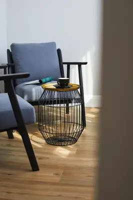 a bird cage coffee table in front of a chair at The Artist Athens in Athens