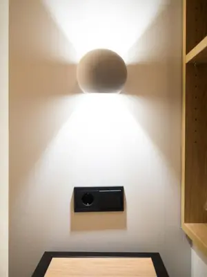 a light fixture on a wall with a camera on it at Luxury Veni Acropolis View Apartment in Athens