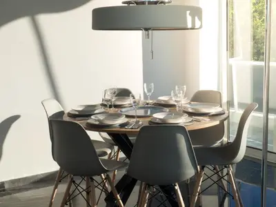 a dining room table with chairs and a lamp at Luxury Veni Acropolis View Apartment in Athens