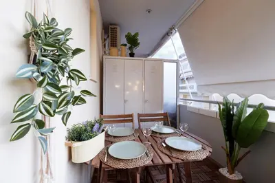 a dining room table with chairs and plants at Athens Premium Suites - Sunny 2 Bedroom Suite with Parking in Athens