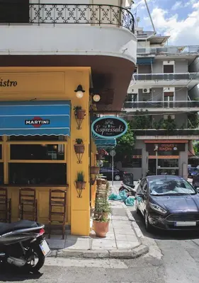 a car parked in front of a building at Athens Premium Suites - Sunny 2 Bedroom Suite with Parking in Athens