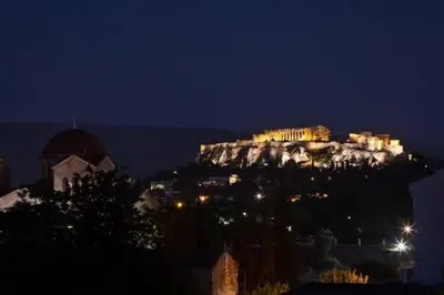 a mountain with lights on top of it at night at 5* Penthouse Acropoli View Loft in Athens