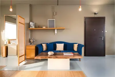 a living room with a blue couch and a table at 5* Penthouse Acropoli View Loft in Athens