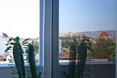 a view of a city from a window at 5* Penthouse Acropoli View Loft in Athens