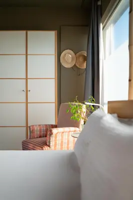 a living room with a couch and a window at 5* Penthouse Acropoli View Loft in Athens