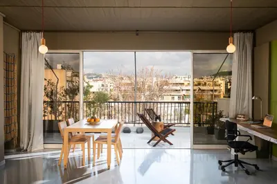 a dining room with a table and a large window at 5* Penthouse Acropoli View Loft in Athens