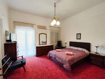 a bedroom with a bed and a dresser and a mirror at Casa Oliver in Athens