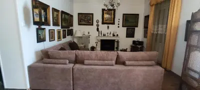 a living room with a couch and a fireplace at Casa Oliver in Athens