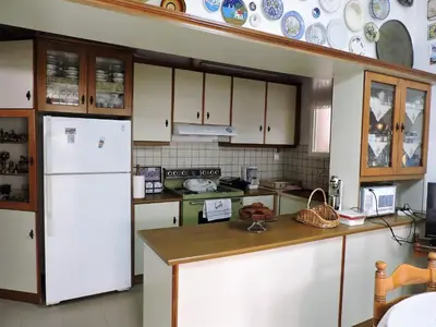 a kitchen with a white refrigerator and a stove at Casa Oliver in Athens