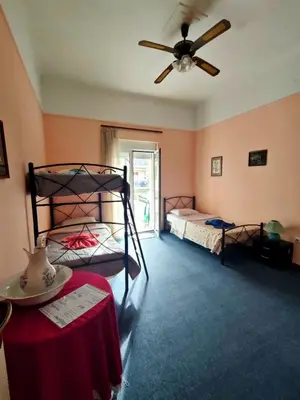 a bedroom with two bunk beds and a ceiling fan at Casa Oliver in Athens