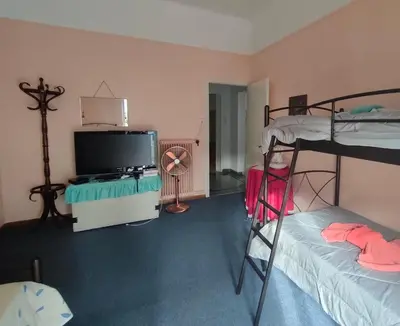a room with two bunk beds and a flat screen tv at Casa Oliver in Athens