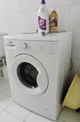 a washing machine with a bottle of milk on top of it at Casa Oliver in Athens