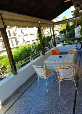 a table and chairs sitting on a balcony at Casa Oliver in Athens