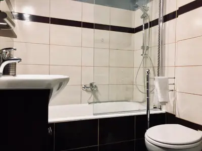 a bathroom with a tub and a toilet and a sink at Athenaeum Acropolis Residence 1min to Museum in Athens
