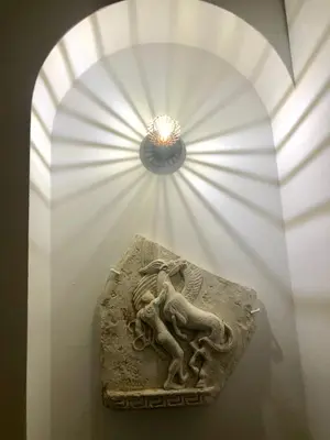 a statue in a display case in a museum at Athenaeum Acropolis Residence 1min to Museum in Athens