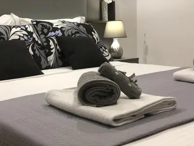 a pile of towels on top of a bed at Athenaeum Acropolis Residence 1min to Museum in Athens