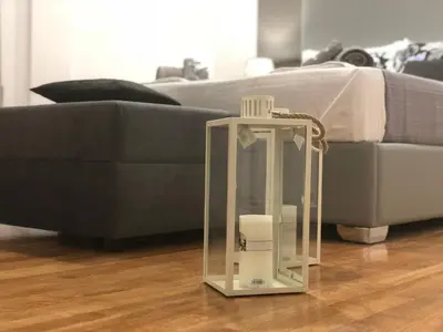 a glass lantern sitting on the floor in front of a couch at Athenaeum Acropolis Residence 1min to Museum in Athens