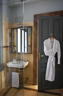 a bathroom with a sink and a mirror at Athenian Vintage Apartments in Athens