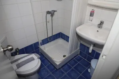 a small bathroom with a toilet and a sink at IKAROS Hotel ELLINIKO in Athens