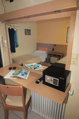 a room with a desk with a mirror at IKAROS Hotel ELLINIKO in Athens