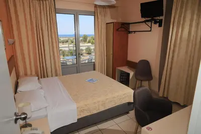 a hotel room with a bed and a window at IKAROS Hotel ELLINIKO in Athens