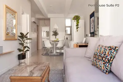 a living room with a couch and a table at The Marble Suites, PLAKA in Athens