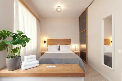 a bedroom with a bed and a potted plant at The Marble Suites, PLAKA in Athens