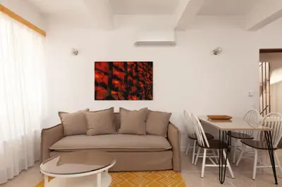a living room with a couch and a table at The Marble Suites, PLAKA in Athens
