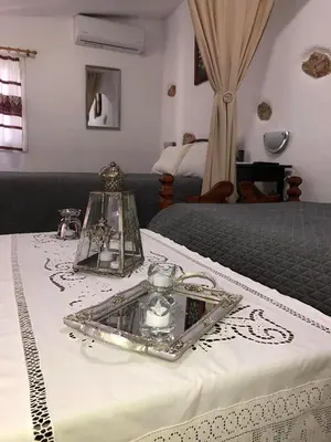a table with a tray on top of a bed at Little cottage in Athens