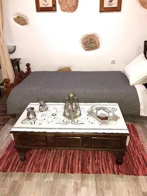 a bedroom with a bed with a coffee table at Little cottage in Athens