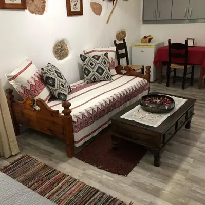a living room with a couch and a coffee table at Little cottage in Athens